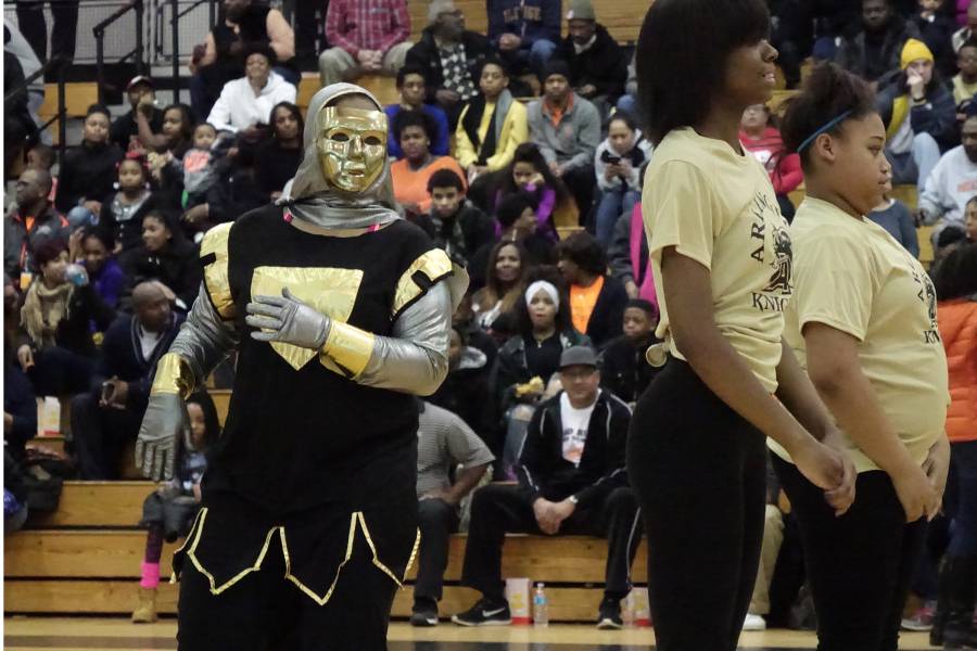 Arlington senior Alyssa dances as the school's mascot, the Golden Knight, during a March 2016 basketball game.