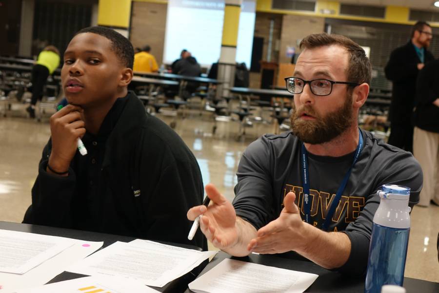 Freshman student Keiveion Anderson and teacher Joe Zwiebel talk with Irvington residents about the changes at Howe during a meeting about the future of the school on Tuesday, November 13, 2018. | By Eric Weddle/WFYI News