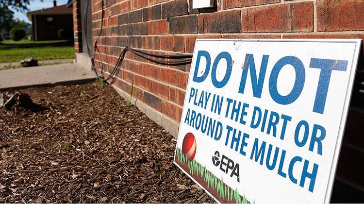 In this Aug. 23, 2016 photo, a sign from the Environmental Protection Agency is posted in front of West Calumet Housing Complex houses at East Chicago, Ind. The EPA has detected high levels of lead in samples of dust and dirt tracked inside homes where soil is tainted with industrial contaminants. The contamination has resulted in the demolition of the low-income complex and relocating its 1,000 residents. - AP Photo/Tae-Gyun Kim