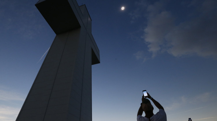 A total solar eclipse is seen above the Bald Knob Cross of Peace Monday, Aug. 21, 2017, in Alto Pass, Ill. Small towns and rural enclaves along the path of April’s 2024 total solar eclipse are steeling for huge crowds of sun chasers who plan to catch a glimpse of day turning into dusk in North America. - (AP Photo/Charles Rex Arbogast, File)