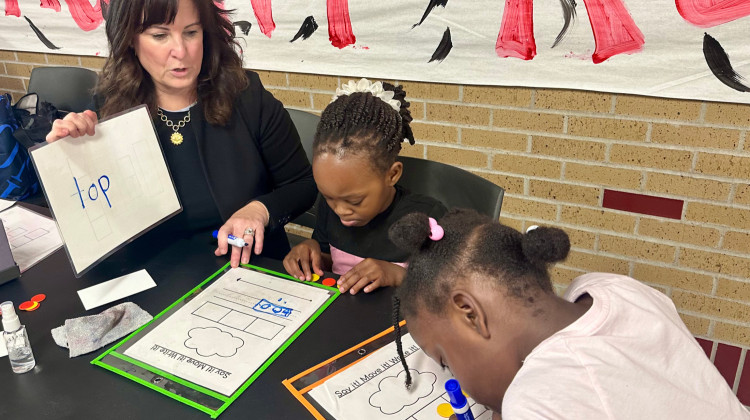 Bridget Kennedy, lead tutor at Pleasant Run Elementary School, leads two students through a phonemic awareness exercise on Wednesday, May 14, 2025. - Rachel Fradette / WFYI