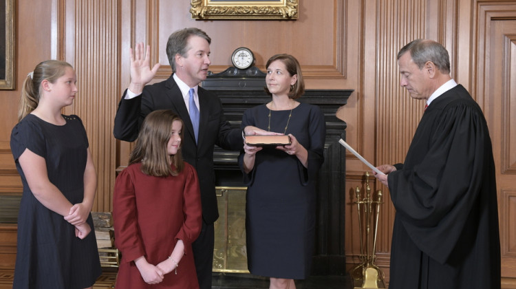 In this handout photo provided by the Supreme Court, Chief Justice John G. Roberts, Jr., administers the constitutional oath to Judge Brett M. Kavanaugh as his wife Ashley Kavanaugh holds the Bible while joined by their daughters Margaret and Liza at the Supreme Court Building on Saturday in Washington, D.C. - Fred Schilling/U.S. Supreme Court /Getty Images