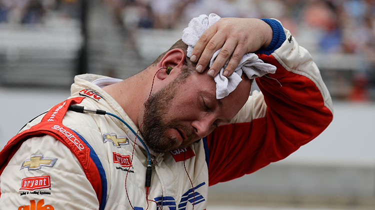 A crew member for Tony Kanaan, of Brazil, cools off during a break during the Indianapolis 500 auto race at Indianapolis Motor Speedway in Indianapolis, Sunday, May 27, 2018.  - AP Photo/Darron Cummings