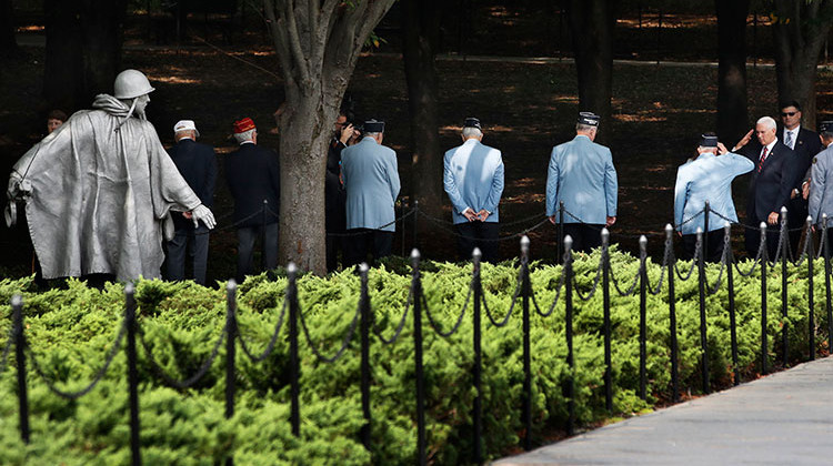 Vice President Mike Pence, right, and a Korean War veteran salute each other as Pence greets Korean War veterans ahead of a ceremony where he presented a American flag that was used during the return of remains from the Korean War in a ceremony in Hawaii in August 2018, to the Korean War Veterans Memorial Foundation, Thursday, Sept. 20, 2018, at the memorial in Washington.  - AP Photo/Jacquelyn Martin