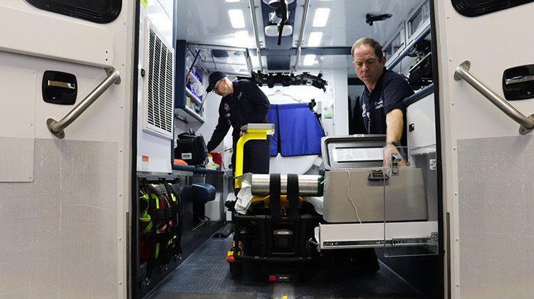 Paramedics Scott Widener (left) and Mike Warnimont (right) prepare the mobile stroke unit for the day. - Paige Pfleger/Side Effects Public Media