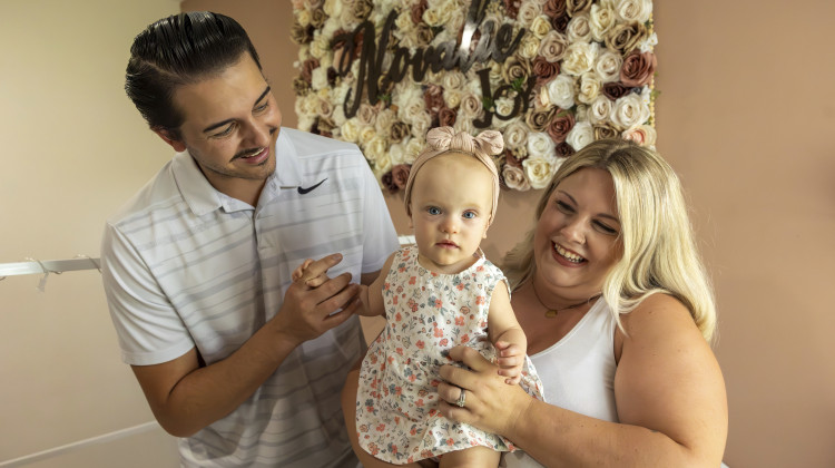 Sam Earle, left, and his wife, Tori, hold their daughter, Novalie, in her room at home Tuesday, May 7, 2024, in Lakeland, Fla. Novalie was born through an embryo adoption. - Mike Carlson / AP Photo