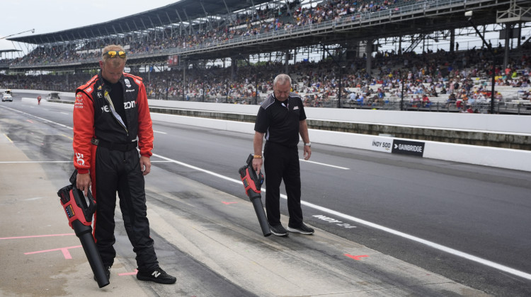 The crew for Will Power, of Australia, dry the pit box before the Indianapolis 500 auto race at Indianapolis Motor Speedway, Sunday, May 26, 2024, in Indianapolis. - Darron Cummings / AP Photo