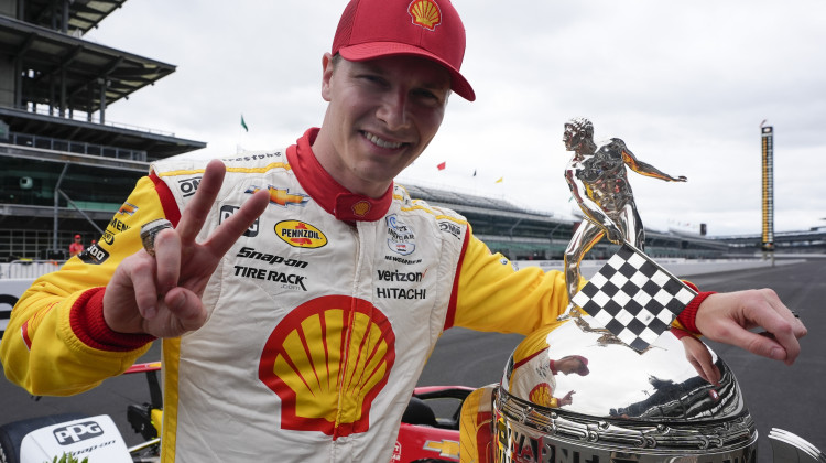 Josef Newgarden poses with the Borg-Warner Trophy during the traditional winners photo session at Indianapolis Motor Speedway, Monday, May 27, 2024, in Indianapolis. Newgarden won the 108th running of the Indianapolis 500 auto race Sunday. - Darron Cummings / AP Photo