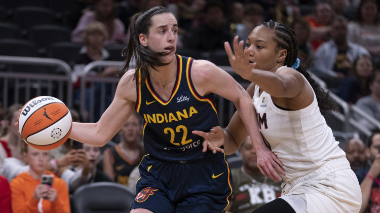 Indiana Fever's Caitlin Clark (22) looks to pass the ball as Atlanta Dream's Naz Hillmon defends during the second half of a WNBA preseason basketball game Thursday, May 9, 2024, in Indianapolis. - Darron Cummings / AP Photo
