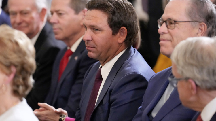 Florida Gov. Ron DeSantis, center, and Indiana Gov. Mike Braun listen as President Donald Trump speaks at an education event and executive order signing in the East Room of the White House in Washington, Thursday, March 20, 2025. - Ben Curtis / AP Photo