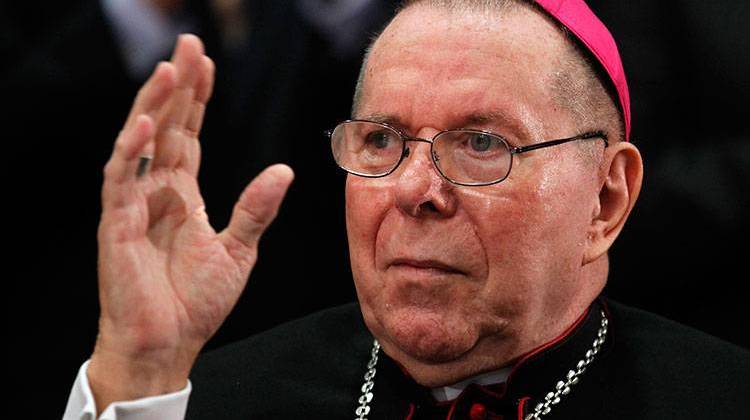 FILE - In this Sept. 21, 2011 file photo, Archbishop Daniel M. Buechlein quiets the applause as he is introduced to announce his retirement in Indianapolis. Archbishop Buechlein, the retired leader of the Indianapolis Catholic Archdiocese, has died at age 79. - AP Photo/Michael Conroy, File