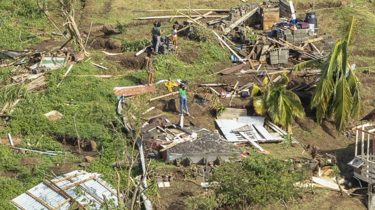 Family members survey their home destroyed by Hurricane Beryl, in Ottley Hall, St. Vincent and the Grenadines, on Tuesday. Beryl is the most powerful storm to form this early in the Atlantic hurricane season. - Lucanus Ollivierre / AP