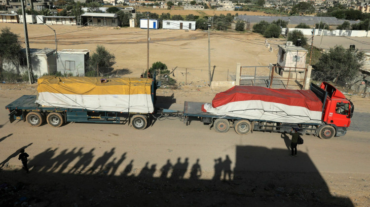 A truck carrying humanitarian aid enters the Gaza Strip via the Rafah crossing with Egypt, hours after the start of a four-day truce in battles between Israel and Palestinian Hamas militants on Friday. - Said Khatib / AFP via Getty Images