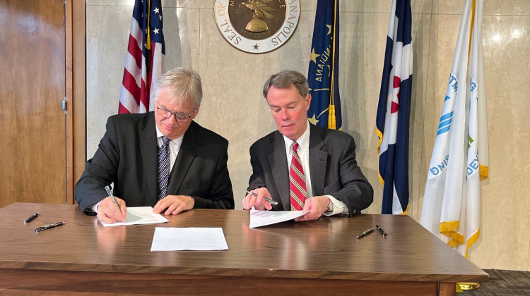 HUD Principal Deputy Assistant Secretary Richard Monocchio and Indianapolis Mayor Joe Hogsett sign the cooperative agreement. - Jill Sheridan / WFYI