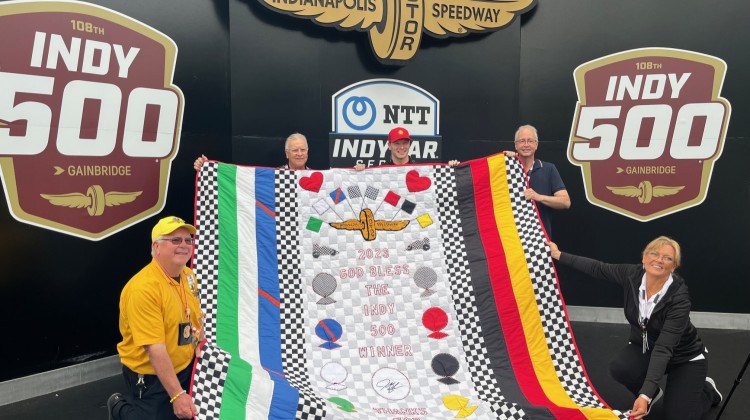 Friends and family of Jeanetta Holder recently presented Josef Newgarden with his winners quilt. - Jill Sheridan / WFYI