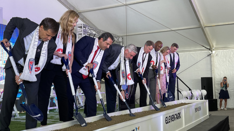Last year Indianapolis Mayor Joe Hogsett joined other city leaders to break ground on Eleven Park. That development is now in question, as the city pursues a potential Major League Soccer team. - Sydney Dauphinais / WFYI