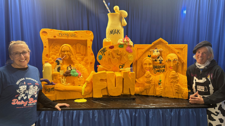 Cheese artists Nancy Baker (left) and Sarah Kaufmann (right) pose beside their cheese sculptures. - Sam Horton / WFYI