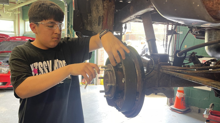John Hernandez works in Arsenal Tech High Schools's automotive shop on Wednesday, May 14, 2025. Hernandez hopes to open up his own car repair shop someday. - Sydney Dauphinais / WFYI