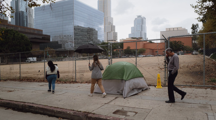Homeless camp sweeps can harm health. Some cities are trying a new way.