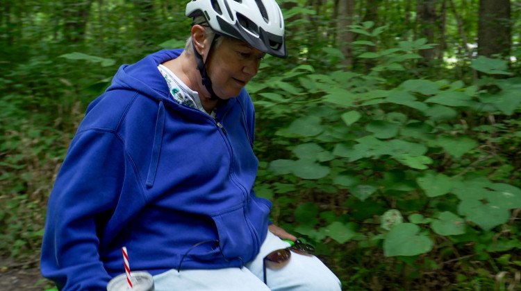 Indianapolis resident Nancy Griffin gets ready to go over a tree root in her motorized wheelchair on a trail at Eagle Creek Park. She said these challenges are what make being on the trail fun. - Alan Mbathi / IPB News