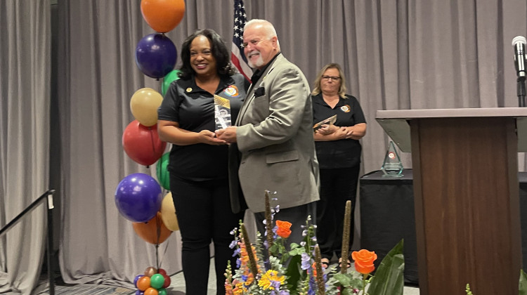 Washington Township Schools Superintendent Nikki Woodson receives an award at the Administrators of Color: Preparing for the Future conference, Monday. Sept. 9, 2024 from Indiana Association of Public School Superintendents executive director Robert Taylor. - Sydney Dauphinais / WFYI