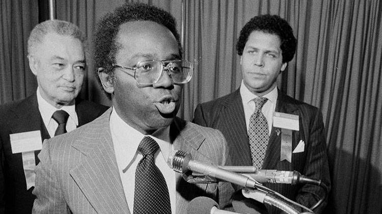 FILE - In this June 12, 1979 file photo, Mayor Richard Hatcher of Gary, Ind., center, reads a telegram to the United States Senate that he and seven other mayors sent regarding a proposal to lift sanctions against Zimbabwe-Rhodesia, in Pittsburgh, Penn., during the U.S. Conference of Mayors.  - AP photo