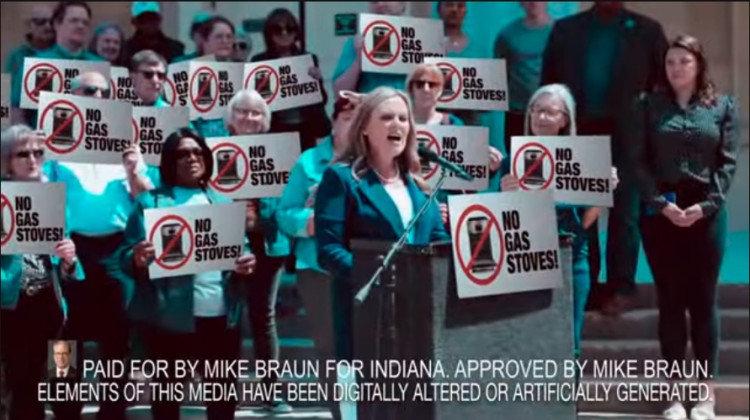 A new negative advertisement from Republican Mike Braun digitally altered the campaign signs at this Jennifer McCormick rally to say “No Gas Stoves!” The version sent to telesivions “mistakenly” omitted the legally mandated disclaimer at the bottom of the screen, according to Braun’s campaign. - Screenshot from Braun advertisement