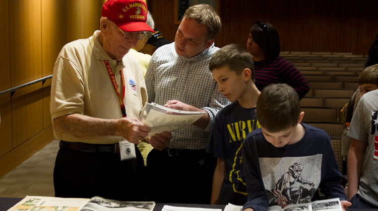 World War II veteran Marion Saucerman shares a photo after a discussion about Pearl Harbor and World War II at the Indiana State  Museum on Wednesday, Dec 7.  - Doug Jaggers/WFYI