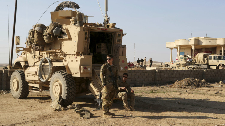 U.S. Army soldiers stand outside their armored vehicle on a joint base with the Iraqi army, south of Mosul, Iraq, Feb. 23, 2017. - Khalid Mohammed / AP Photo, File