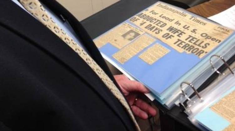 Rep. Woody Burton, R-Whiteland, holds a scrapbook his mother made about her ordeal with domestic violence. Burton testified Wednesday, Feb. 4 at a committee hearing about expanding state funding for family violence prevention. - Photo by Brandon Smith,IPBS